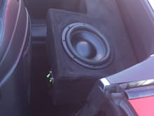 Sundown audio sub is wrapped in same material as steering wheel and headliner