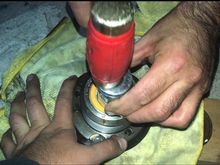 Installing new bearing into pulley using a socket that fits perfectly around inner ring of bearing 