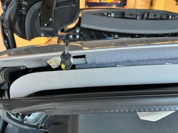 I separated the Female and Male Velcro strips, cutting and attaching the Female to the roof in several strips 4-5 inches each across the back edge of the roof, and a 10 or so smaller 2 inch size male strips attached to the headliner in the gaps between the previous attachments and support arms. You will use more female strip material as a result. This picture shows Female installation on one side of old fastener, I put it end to end on roof.