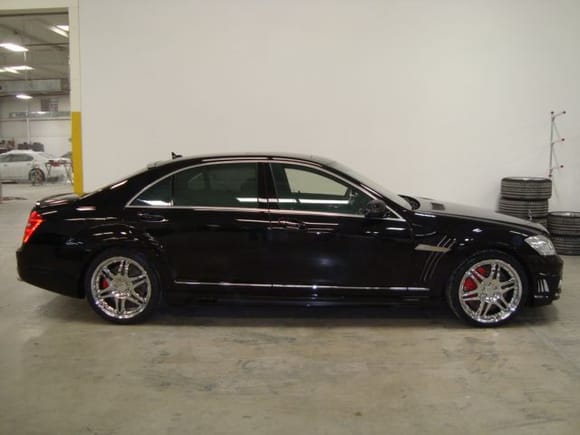 Black Bison Side view with custom 2 tone side skirts, custom painted calipers, custom made lights that are inserted into Black Bison Fenders