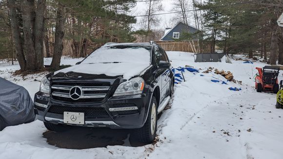 There she sits, where the tow truck dropped it off 😞

Sadly a few weeks ago while my wife was just running to the store, car suddenly shuts down on the highway. I'm pretty sure the OM642 is seized. The worst part is it only had 70k miles and it's my fault. It's not driven very much, about 12km a day so I've kind of neglected oil changes. Oil cooler seal started leaking 2 years ago and I never got around to fixing it, I did however check the oil every month and kept it topped up. 