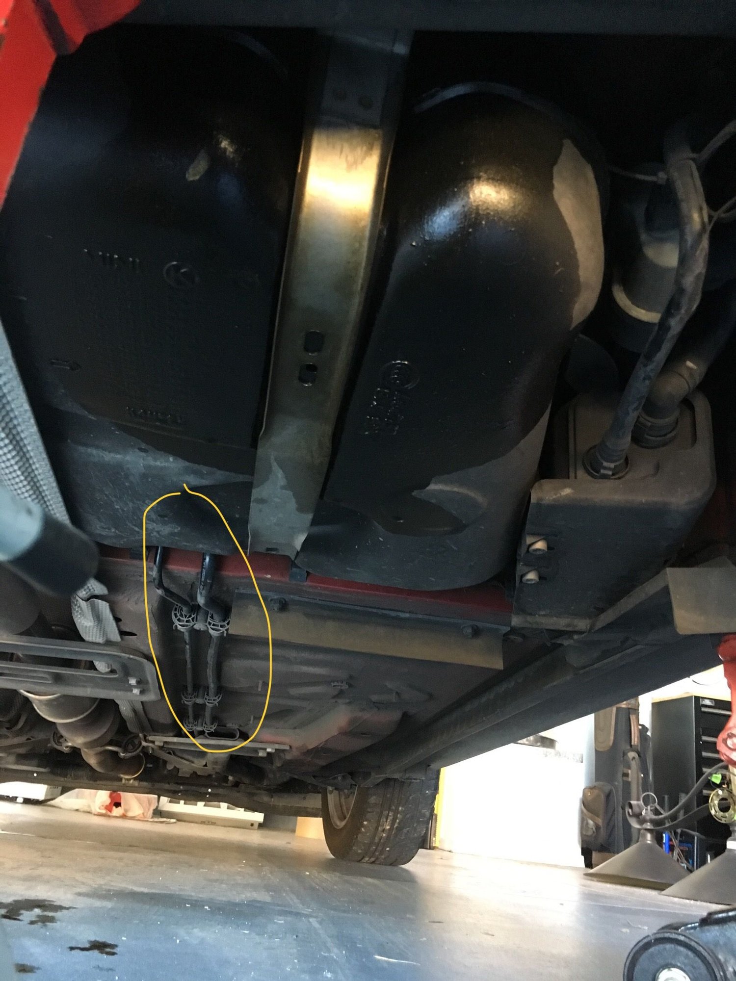 Brown fluid leak from above fuel tank North American Motoring