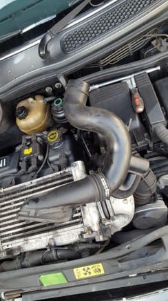 Remove Intake Pipe. There are clips on the end at the front of the car and pry up. The other end just pushes in to the air box. There is a small finger that keeps it in place near the ECU box. Get the front end off and the air box end will wiggle wiggle out.