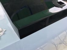 The wooden block for the steering has to go below the horizontal black line to break up that space better. Paint alone looks too artificial. The wood block is a little of a retro touch mainly found on fishing boats, but I think it will work here