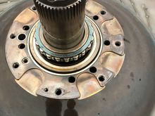 Bearing housing and pinch plate is now removed
exposing  the bearing
Take note on the three crush seals
Im gonna shine a flashlight thru the holes to see
If i can see anything!