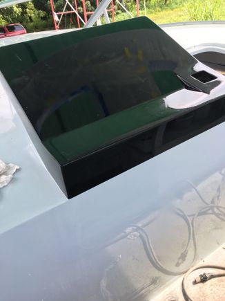 The wooden block for the steering has to go below the horizontal black line to break up that space better. Paint alone looks too artificial. The wood block is a little of a retro touch mainly found on fishing boats, but I think it will work here
