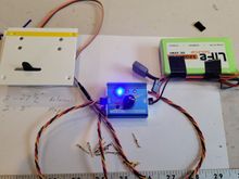 I've installed one end of the extension to my aileron servo, the opposite end of the extension is inserted into my servo tester.  A battery is powering the tester.  I wiggle each wire terminal to make sure of good positive connection.   This servo tester can center your servo. or it can be set to manually control the servo by the black knob on the tester.  This servo tester will also "burn-in" your servos by continuously cycling the servo from one end point to the other indefinitely.