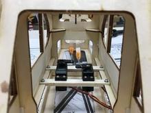 Here, the second rail and the servos are screwed down. I connected the front end of the pushrods with . . .