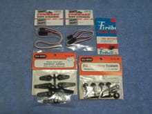 2 Fuetaba Receiver to Servo Wires, one 12 inch and one 24 inch, one package of Servo Arms, one Fill It Fueling System, and one Fireball Glow Plug.  All items are new and in their original packaging.  
