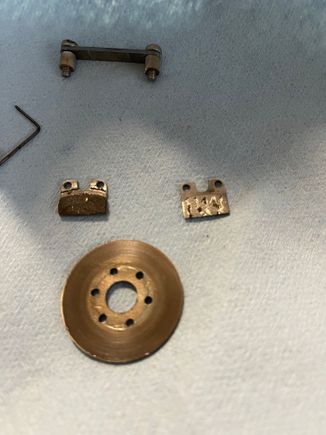 You can see here how one side of the brake actuator is missing brake pad material.

I found some extra brake looking stuff from my RC car stuff and made the magic happen. 

The brakes worked incredible after putting the new brake material on.