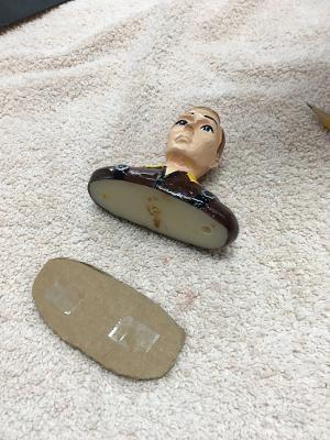 Normally, I would just glue the pilot in with silicon caulk or canopy glue. I wanted this one to be removable in case the winner of this model wanted to personalize it. Here, the cardboard pattern is ready to attach to the pilot with double-faced tape.