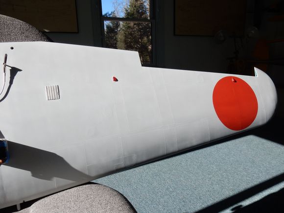 Upper port wing surface showing wing-walk pad, formation lights and lightening hole detail on inside edge of wingtip trailing edge rib.