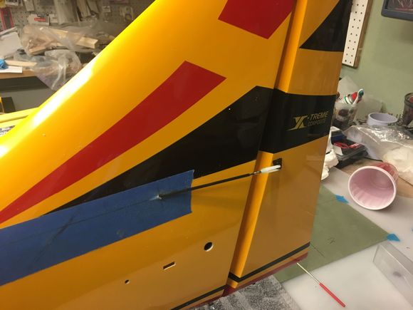 Checking the angle of the cutout hole with a 48" piece of carbon fiber tube.