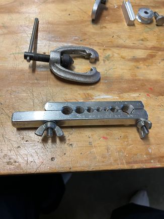 I started every bend with a flange already on the tube. This is how I flanged. First I used the "normal" side of the clamp rig to start the flange (with round end of a small ball peen hammer).  This side has a bevel on the lip. Once bevelled I move to the other (flat side of the rig). . . .   .