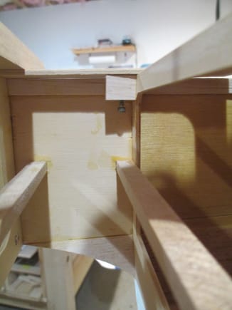 I insert the 4-40 screw through the bottom of each of the basswood blocks and firmly press the screw against the bottom of the crutch.