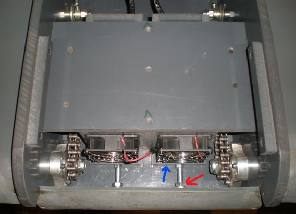 Motors mounted to sleds basically.  As the nut (red arrow) is loosened, it pushes on the back of the tank elongating the bolt which pushes the motor sled toward the front of the tank (blue arrow) taking up the slack.