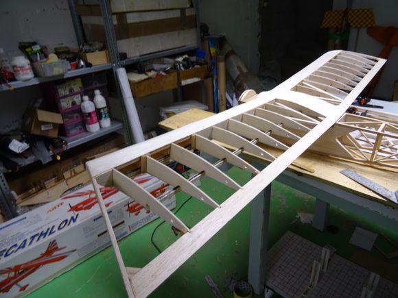 Lightweight three-spar wing for my reserve Baron on top of its new fuselage, the nose of  which has bee shortened by 2 cms to allow for the extra weight of a 52 four-stroke. 