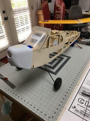 The fuselage stands on the mains for the first time. The cowl and windshield fit acceptably.