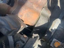 Top of water pump, alternator removed. Damp patch at gasket between pump and front iron. 