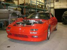 New SQ paint ( Blaze Red ) on the '89. Flourescent lights make it look more orange than it is . New Shineauto Half Front bumper added before paint .