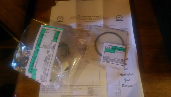I got my two parts in from the Mazda online parts system at Jim Ellis Mazda. The front shim for the bell housing and the shifter return spring.