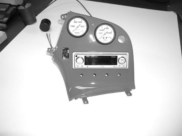 Here you can see the center console with the fuel pressure and oil temperature gauges, the Pioneer head unit, and the 4 holes below that would be for the fan, temperature, where the air blows, and Air Conditioning On/Off switches. 