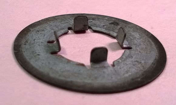 Another view of the rear caliper bracket washer I'm hoping to verify that it belongs on the car.