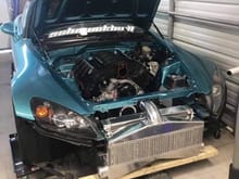 Here is one with a custom intercooler, even setup to go above it and under rad support. It will likely have to be this way because of the hood clearance from that rad support. 