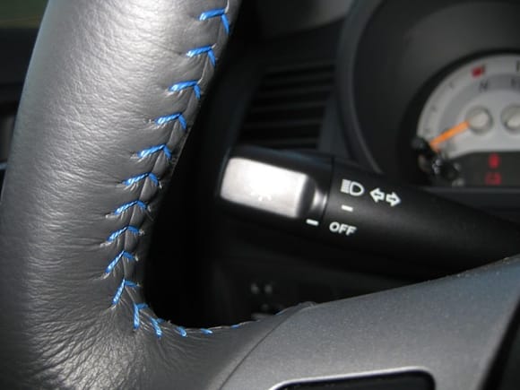 blue stitching on the steering wheel