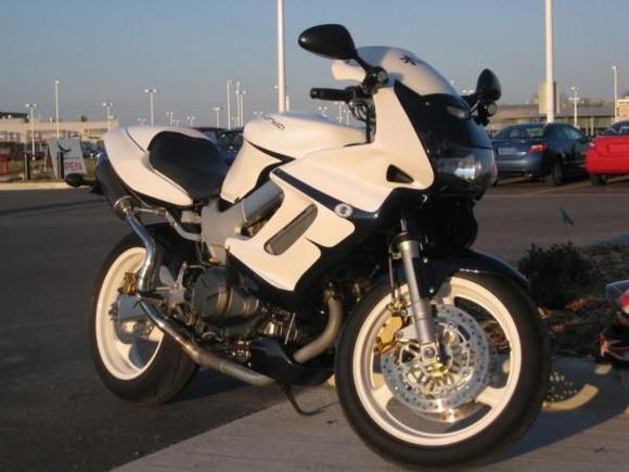 painted white with blue pearl, white powder coated wheels