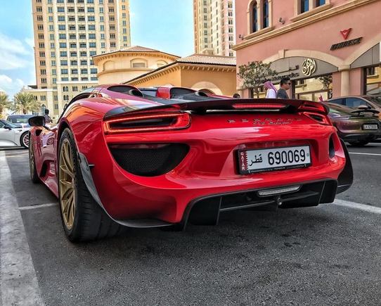 Red Porsche 918 Spyder Weissach with gold rims.