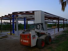 This is from a couple of weeks ago, but you can see the lift.  Now both long sides are done.  Probably take about 6 hours to finish the ends and trim, then we can get going on the roof.  After that some floor epoxy, and we're good to go.