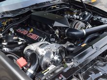 Stock 5.3, remove engine cover and swap or use OeM small case alternator. Everything clears.