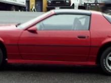 After Restoration 85 Camaro Driver Side View w/  Spoiler, GFX and Stock Paint.