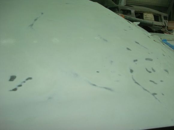 Passenger front half of roof. All the bare metal spots are high spots and the shiny unsanded ones are low spots.