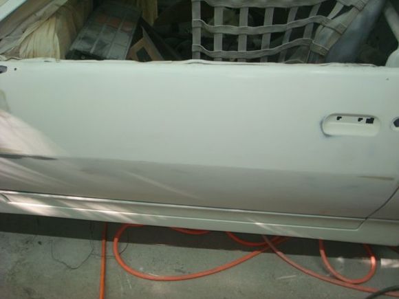 Blocked the door to get the center body line cleaner. You wont see it once the car is painted and decaled though as it gets a black vinyl divider strip down the center to break the paint colors.