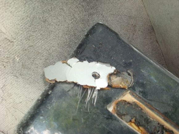 Silver paint on the back side of the emblem glue tells me it was replaced while MC was racing it.