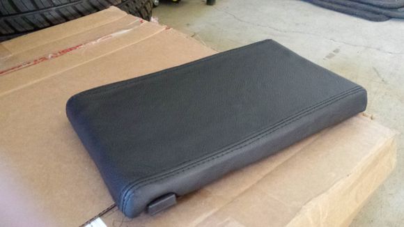 Recover in leather of centre console lid (couldn't get a decent lid or even a cover in North America - had to get a custom order made in UK)