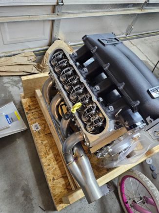 Engine and intake showed up so I put the exhaust manifolds on upside down for now so they don't stick up too much and I can slide this under the bench.  Smedding got this done quick.  I didn't expect it for a while and BTR said everything was backorder but then it showed up.