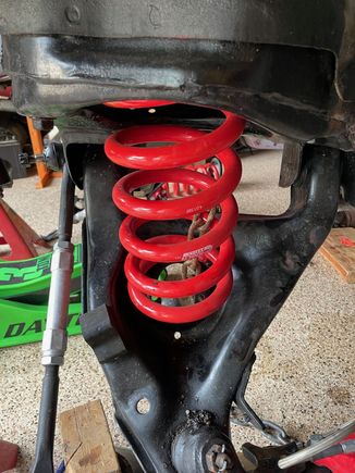 You can see that the spring is upside down.  I found Eibach installation instructions online and it says that the labeling should be right side up and the flat end of the spring should be up top.