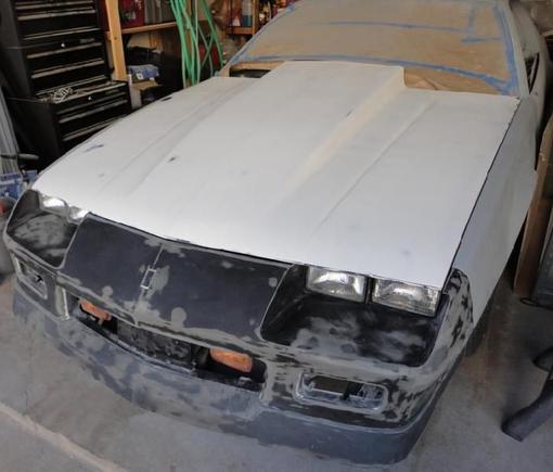 Got the hood aligned this weekend.  Considering a bolt on, fiberglass cowl induction hood I only had to knock down the front edge flange about a 1/4" to get it to clear the front bumper.  Very nice hood.