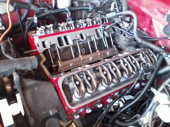 Got the heads painted and put on, almost done! Didn't have the tools or time to pull the block and clean everything but its a daily driver so whatever. A new engine is in the future anyways once I get a good job. Just waiting for the intake to get back from the sandblasters to paint it and put it on