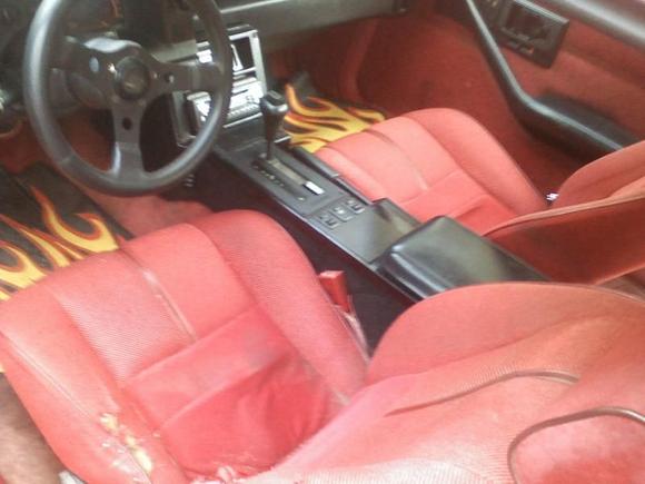 sorry for the bad quality, pic done w/cell. But this is the console painted black and you can see the ps armrest is also black. The tear in the driver seat is the only tear in the interior. The back is also black but since all I have is a cell for a camera I havent been able to get a good enough pic to post.