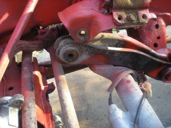the removed bolt holding the front axle on the pass side