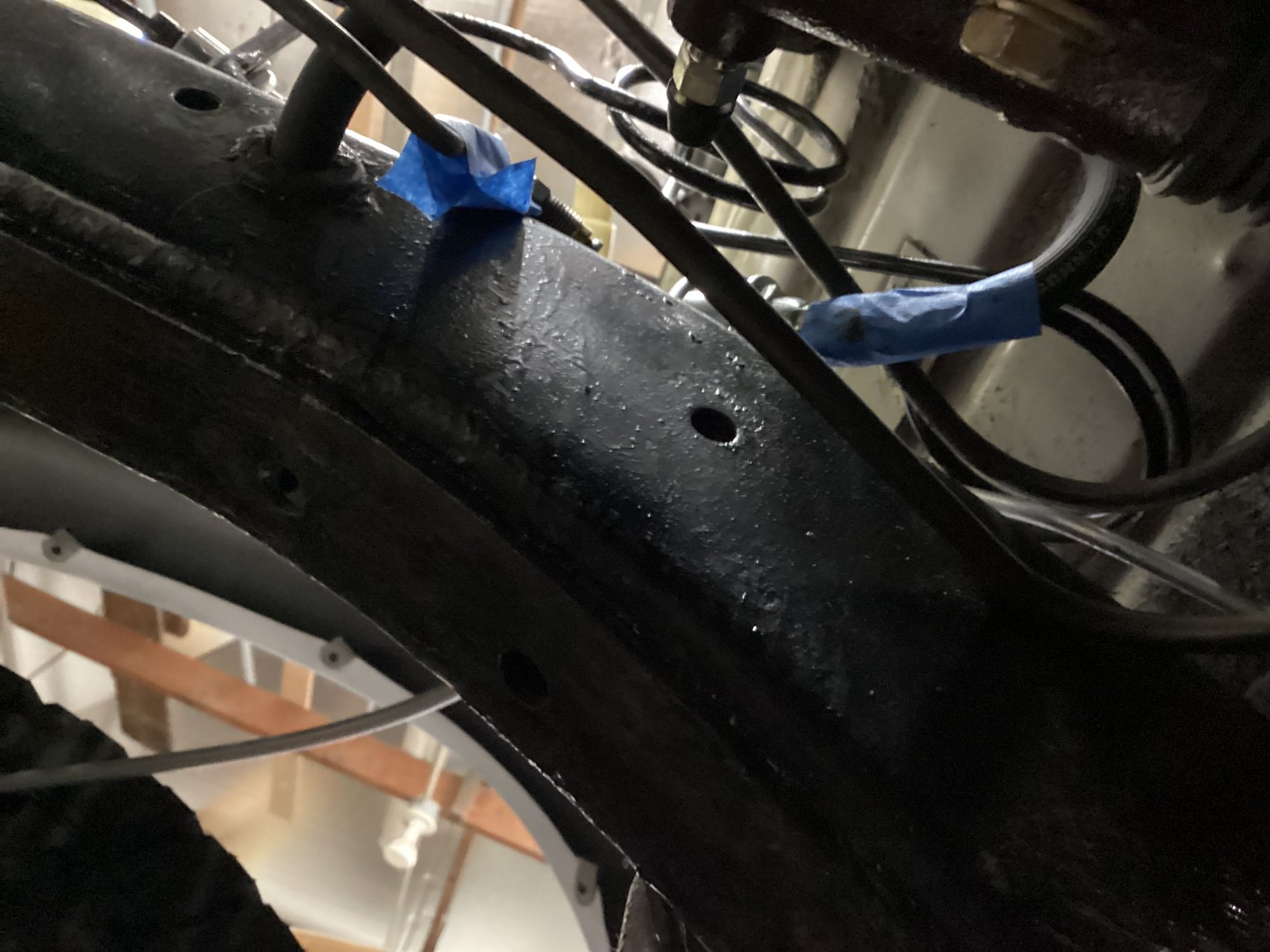 View from below looking up at the two slave cylinder lines (marked with blue tape).