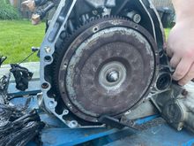 Torque converter unseated because it was held (barely) by some random cover plate and screw.