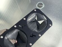 Rubber membrane stops cans from moving around.