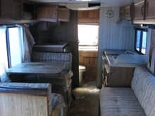 dining turns into single bed. bathroom and shower in the back. coach turns into a twin and over the cab is another twin. fridge and freezer 4 burner stove and oven a/c running water ect.