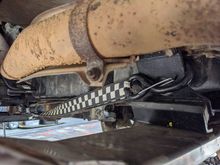 Same problem with the tranny mount, totally shot. I replaced it as well. You will notice strap. lol. The engine and tranny had moved backwards by 1/2, i thought the bad engine mounts caused it. I think lifting the suspension changed the angle and pulled the drivetrain backwards. I made my crossmember holes in stock location then had to slot them. Got to figure that out...