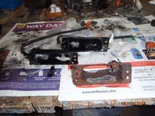 the three remaining light housings - one "as removed", one painted, and one painted and encased with fiberglass